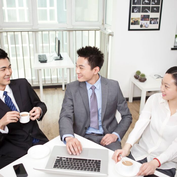 Group Of Business People Chatting In Office