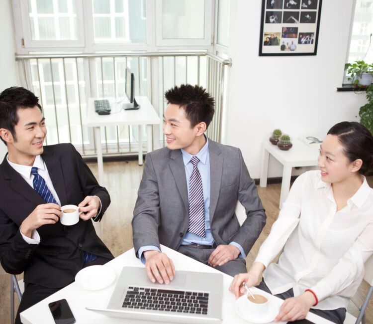 Group Of Business People Chatting In Office